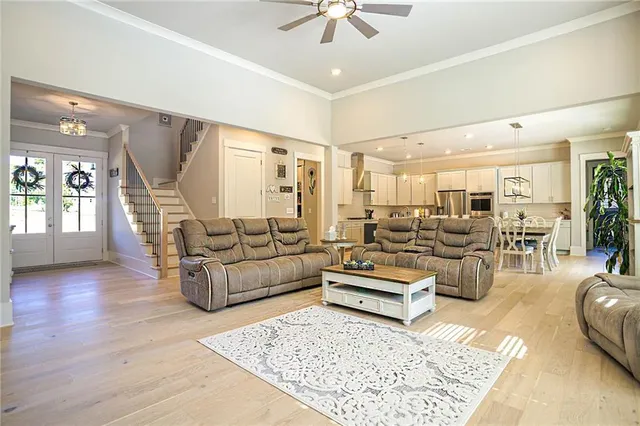 a living room with furniture and wooden floor