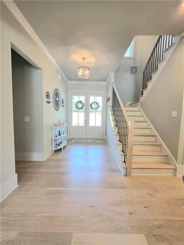a view of entryway and hall with wooden floor