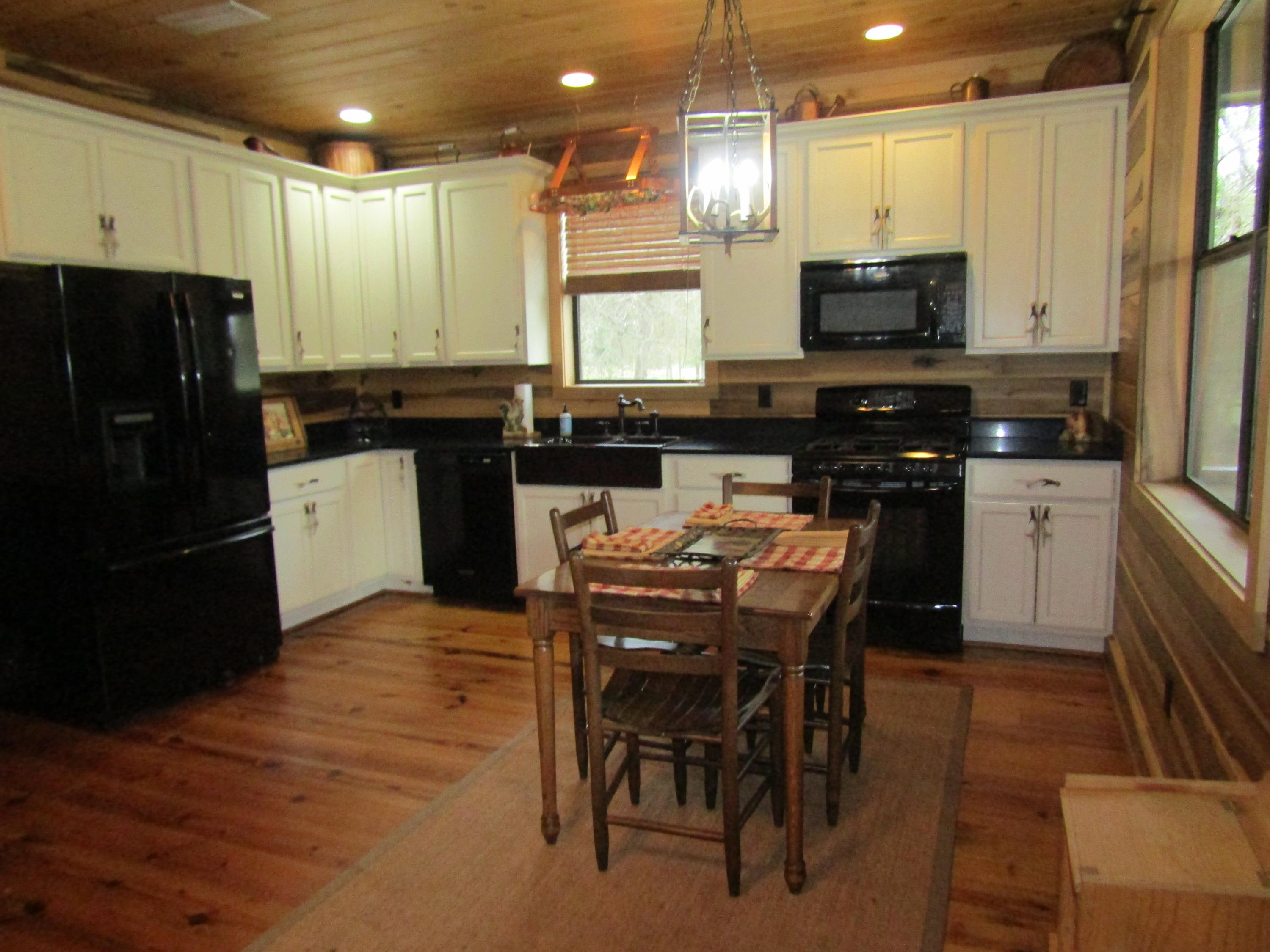 2948 Alford Road Samson, AL 36477 - Photo 14 of 121 a kitchen with stainless steel appliances kitchen island granite countertop a stove top oven a sink a dining table and chairs