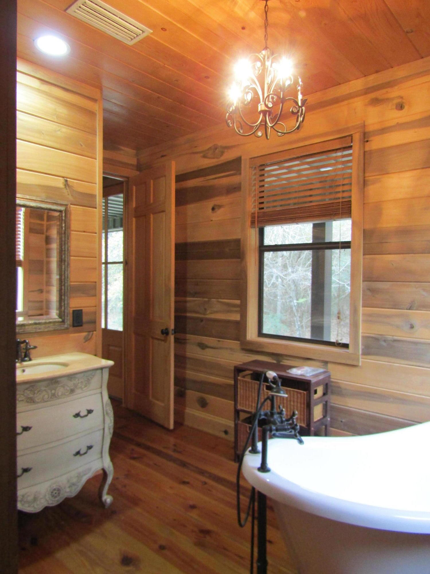 2948 Alford Road Samson, AL 36477 - Photo 19 of 121 a bathroom with a sink a large mirror and a bathtub next to a window