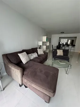 a living room with furniture and a lamp