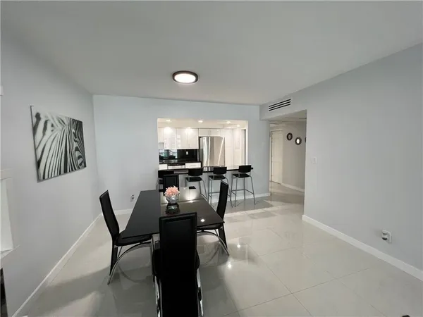 a dining room with furniture and a chandelier