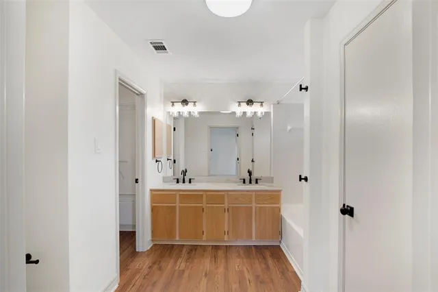 a room with a wooden floor and a sink