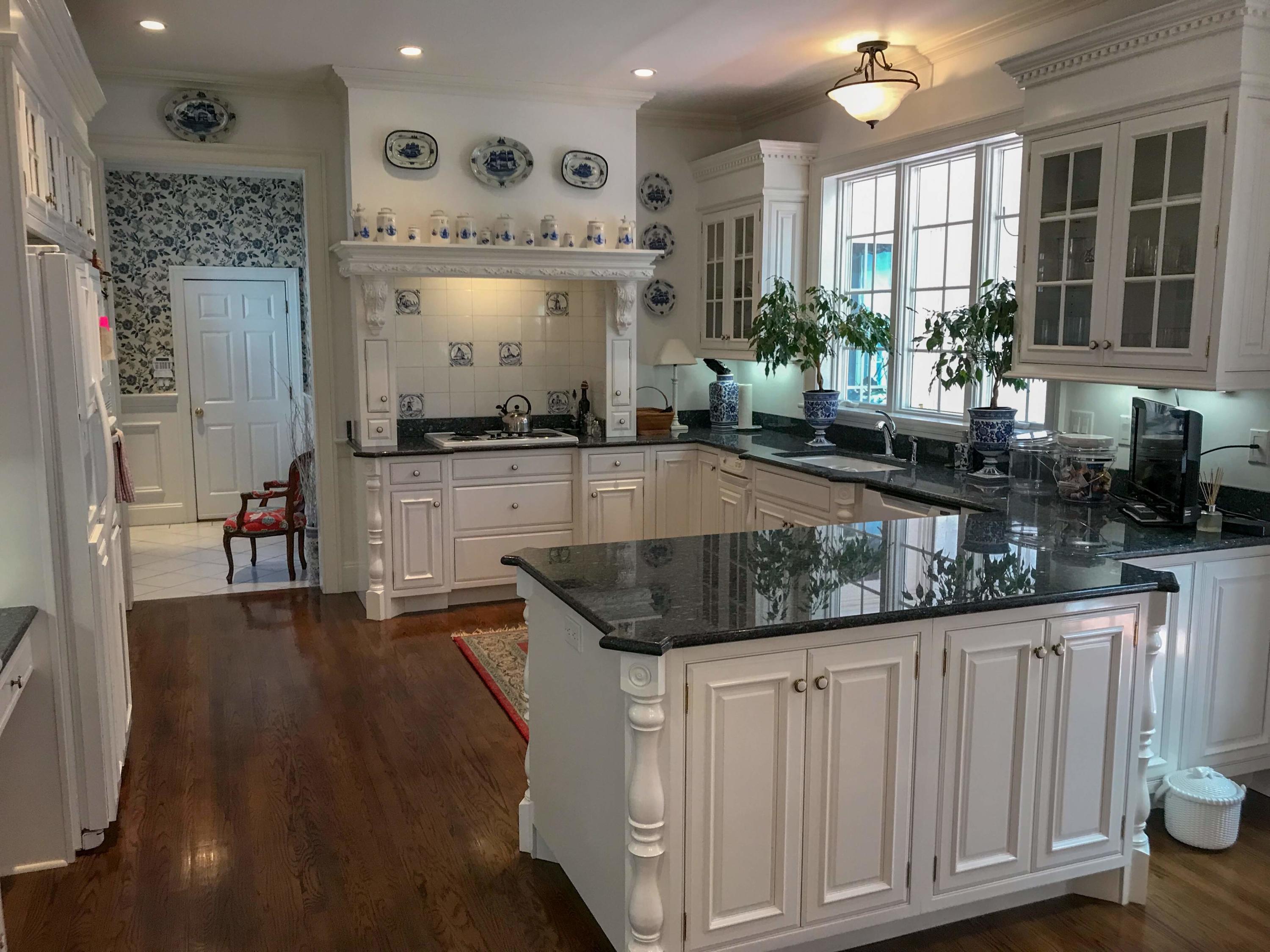 163 Pineleigh Path Osterville, MA 02655 - Photo 8 of 23 a kitchen with stainless steel appliances granite countertop a stove and a wooden cabinets