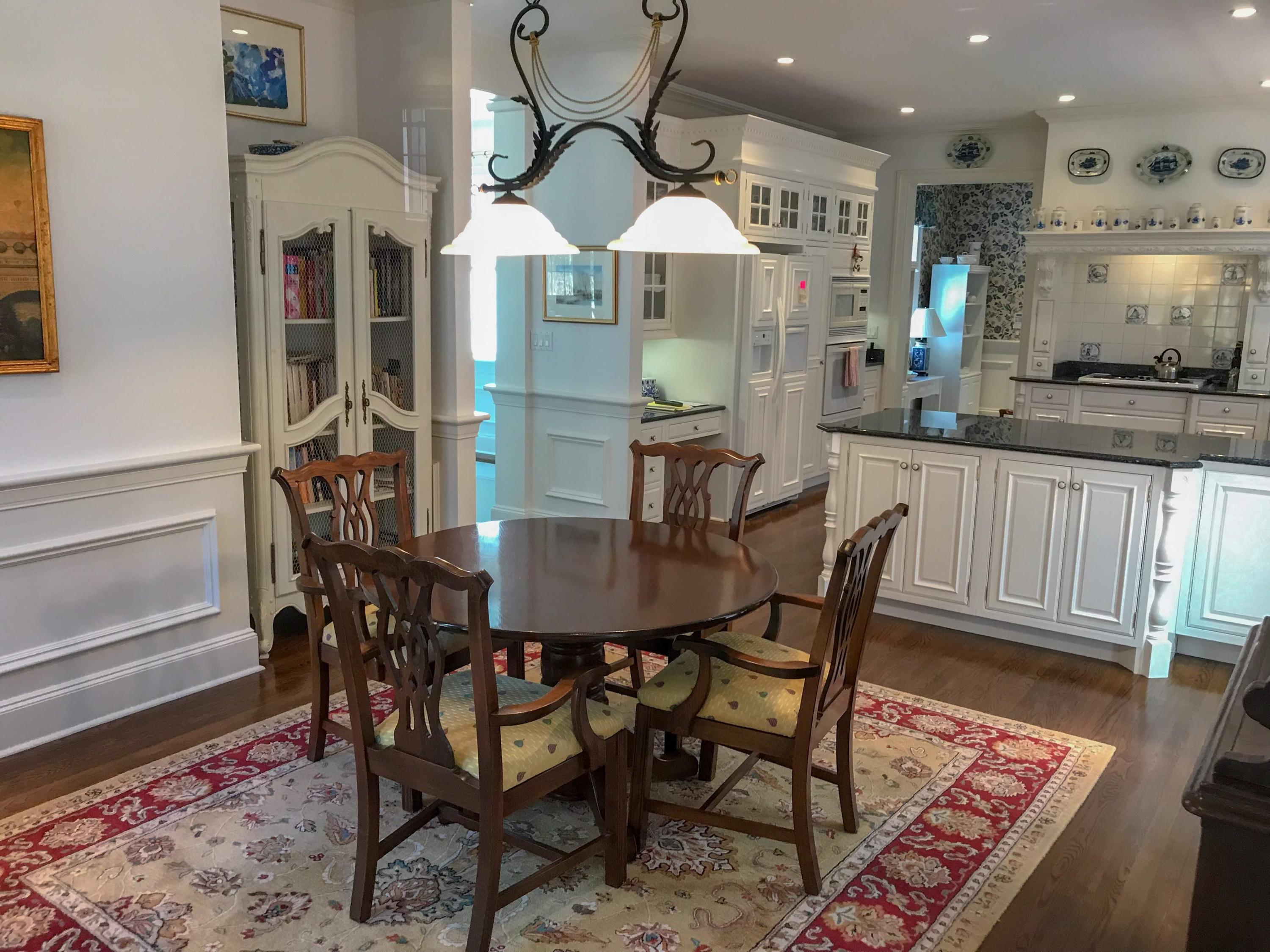 163 Pineleigh Path Osterville, MA 02655 - Photo 9 of 23 a kitchen with stainless steel appliances a dining table chairs and wooden floor