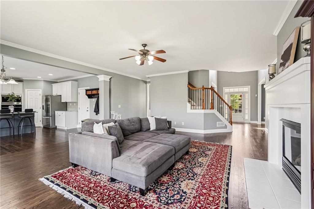 4708 Arbor Crest Place Suwanee, GA 30024 - Photo 16 of 102 a living room with furniture and a fireplace