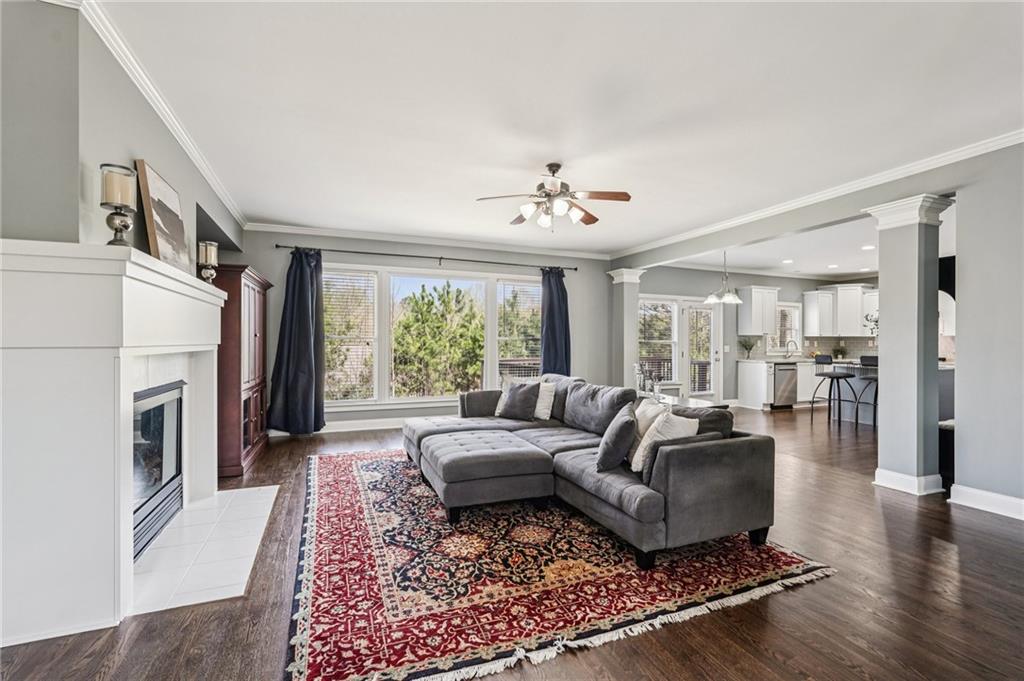 4708 Arbor Crest Place Suwanee, GA 30024 - Photo 17 of 102 a living room with furniture fireplace and a large window