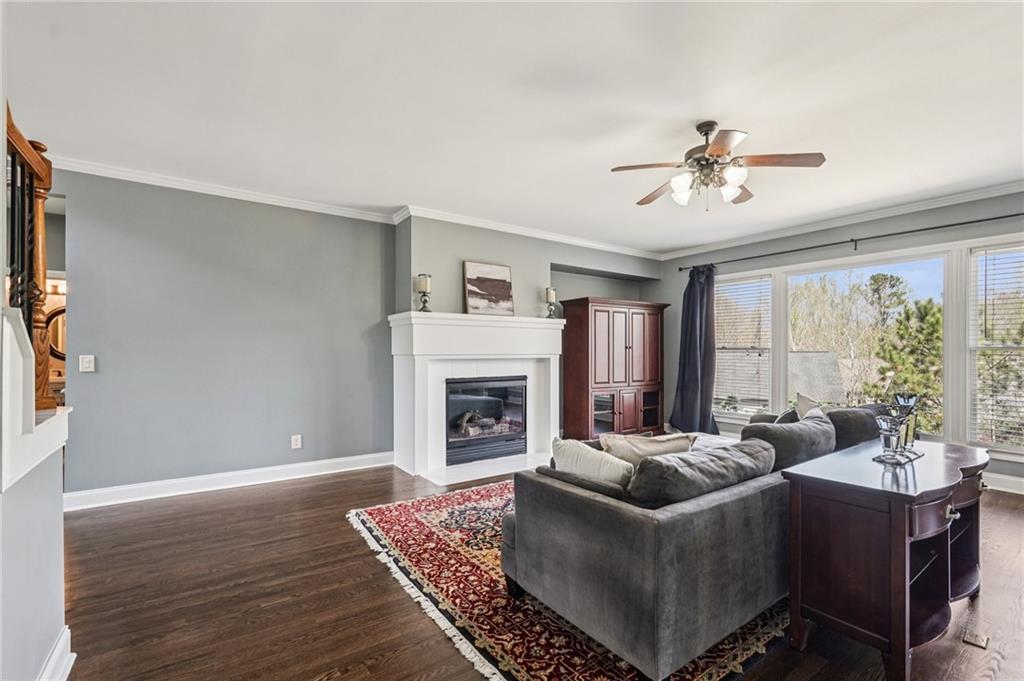 4708 Arbor Crest Place Suwanee, GA 30024 - Photo 18 of 102 a living room with furniture and a fireplace