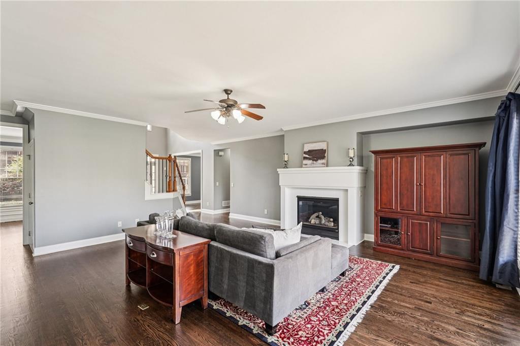 4708 Arbor Crest Place Suwanee, GA 30024 - Photo 19 of 102 a living room with furniture and a fireplace