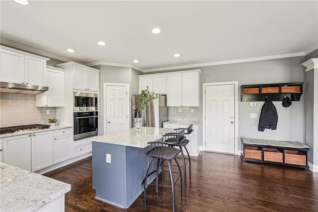 4708 Arbor Crest Place Suwanee, GA 30024 - Photo 26 of 102 a living room with stainless steel appliances kitchen island granite countertop furniture a kitchen view and a refrigerator