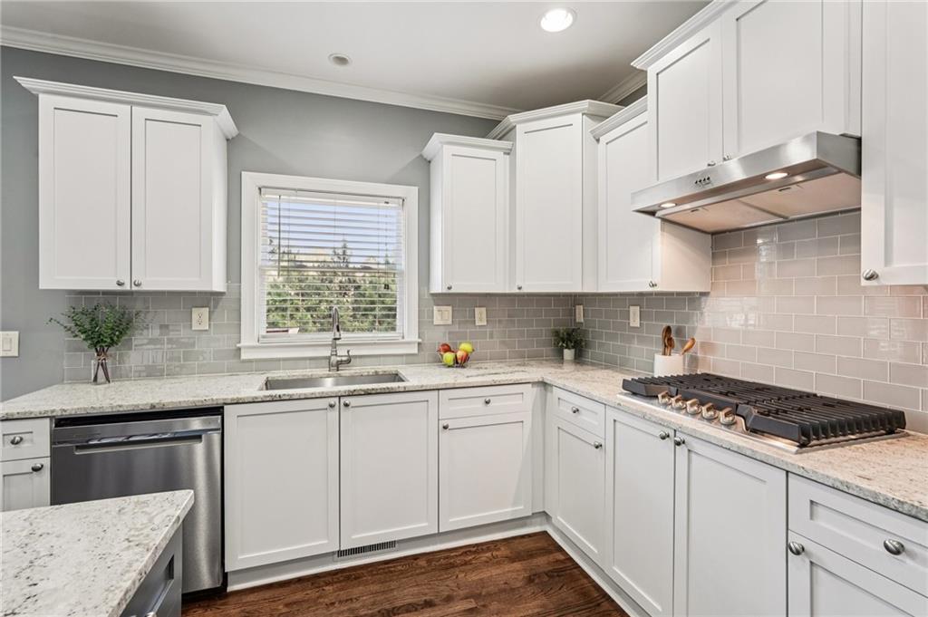 4708 Arbor Crest Place Suwanee, GA 30024 - Photo 31 of 102 a kitchen with stainless steel appliances granite countertop a sink stove and cabinets