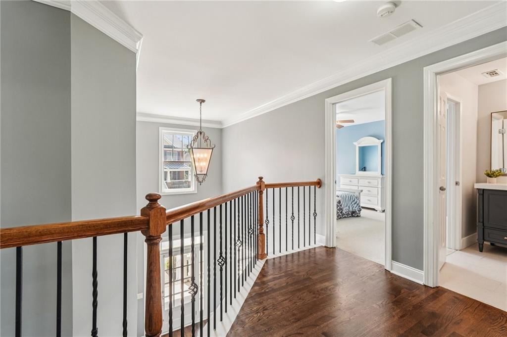 4708 Arbor Crest Place Suwanee, GA 30024 - Photo 32 of 102 a view of a hallway with wooden floor and a living room