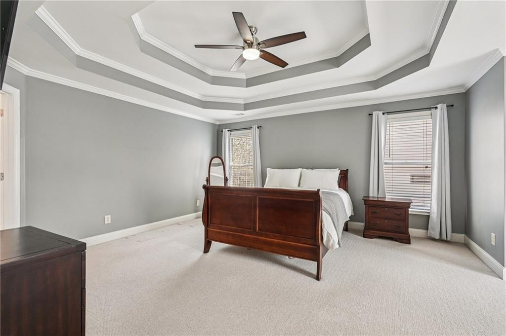 4708 Arbor Crest Place Suwanee, GA 30024 - Photo 35 of 102 a bedroom with a bed and ceiling fan