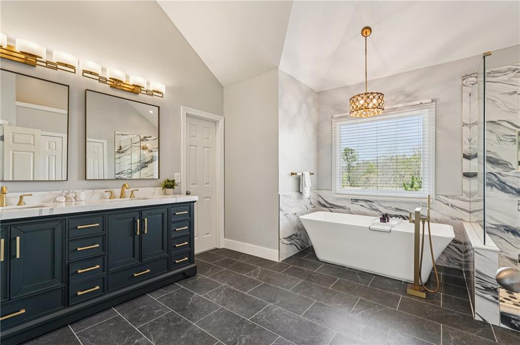 4708 Arbor Crest Place Suwanee, GA 30024 - Photo 40 of 102 a spacious bathroom with a tub sink and mirror