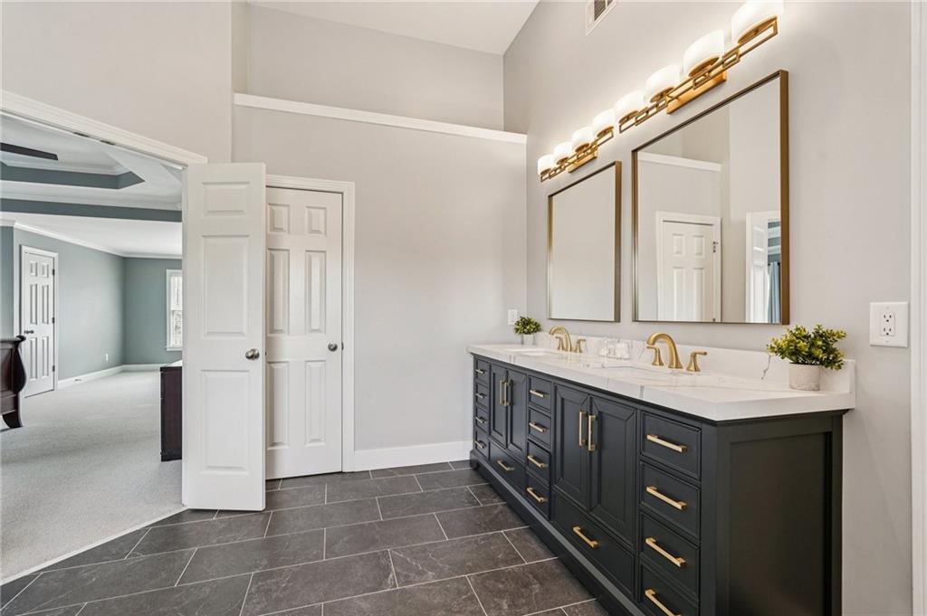 4708 Arbor Crest Place Suwanee, GA 30024 - Photo 42 of 102 a bathroom with a double vanity sink and a mirror