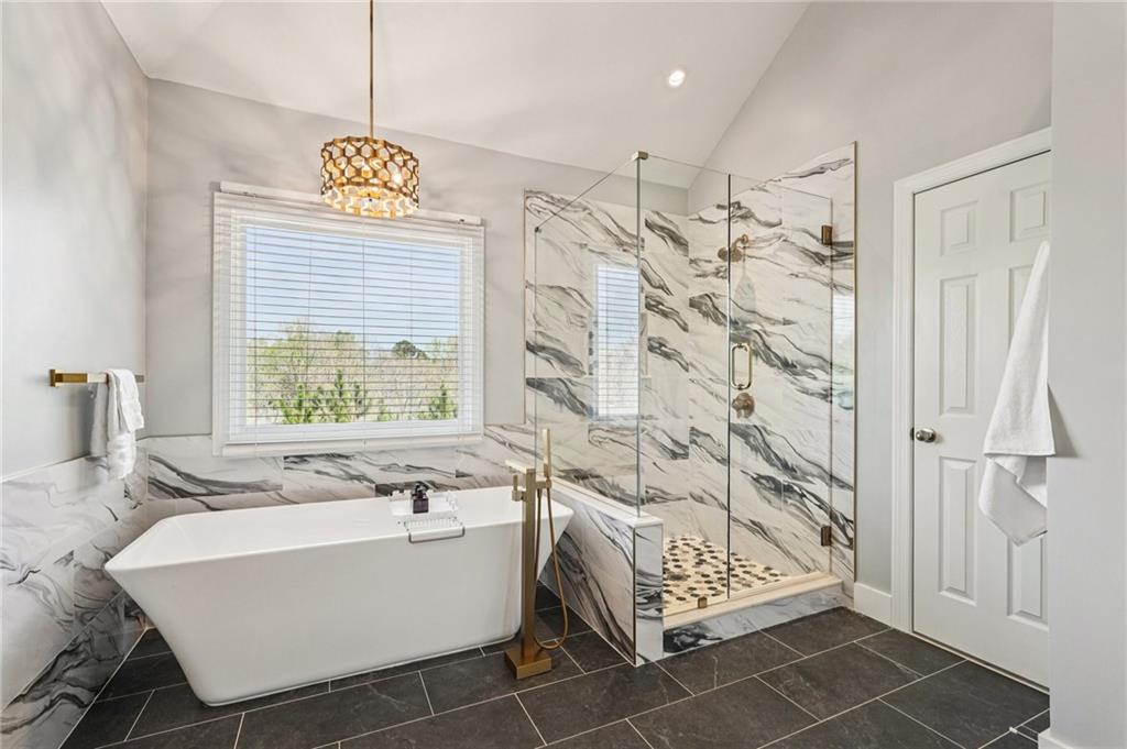 4708 Arbor Crest Place Suwanee, GA 30024 - Photo 43 of 102 a bathroom with a sink a bathtub and a shower