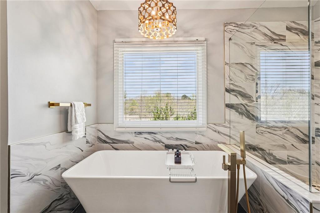 4708 Arbor Crest Place Suwanee, GA 30024 - Photo 44 of 102 a bath tub sitting in a bathroom next to a window