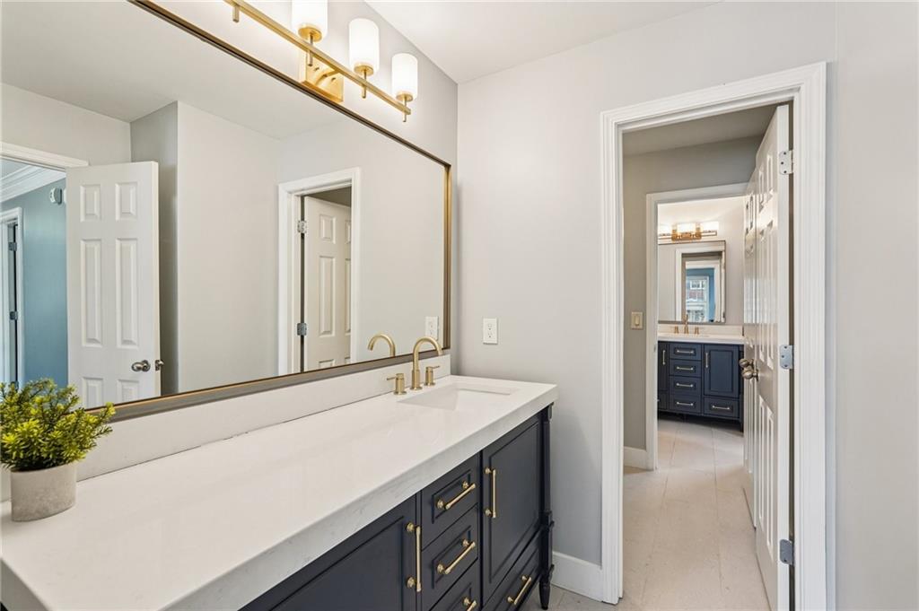 4708 Arbor Crest Place Suwanee, GA 30024 - Photo 55 of 102 a bathroom with a sink a mirror and a bathtub