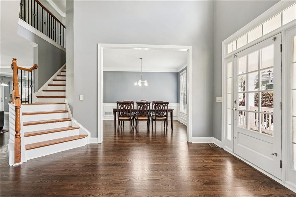 4708 Arbor Crest Place Suwanee, GA 30024 - Photo 6 of 102 a view of entryway and dining room with wooden floor