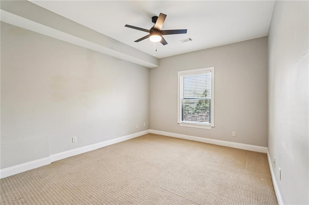 4708 Arbor Crest Place Suwanee, GA 30024 - Photo 67 of 102 an empty room with ceiling fan and window