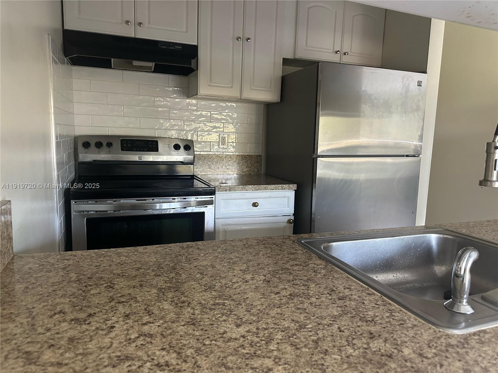 6031 10th Avenue North, Unit 218 Greenacres, FL 33463 - Photo 5 of 9 a kitchen with a refrigerator stove and microwave
