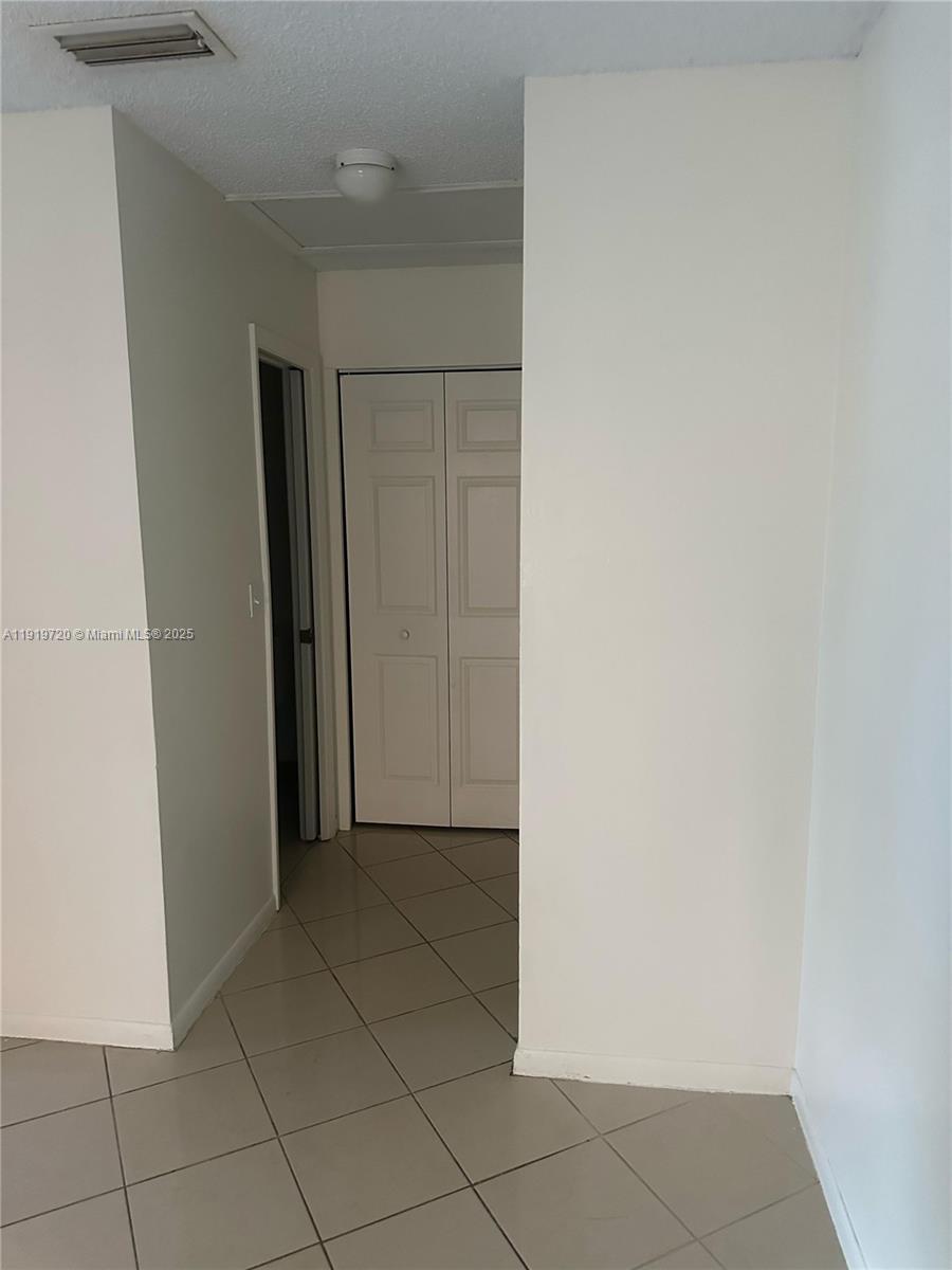 6031 10th Avenue North, Unit 218 Greenacres, FL 33463 - Photo 6 of 9 a view of a closet area in a room
