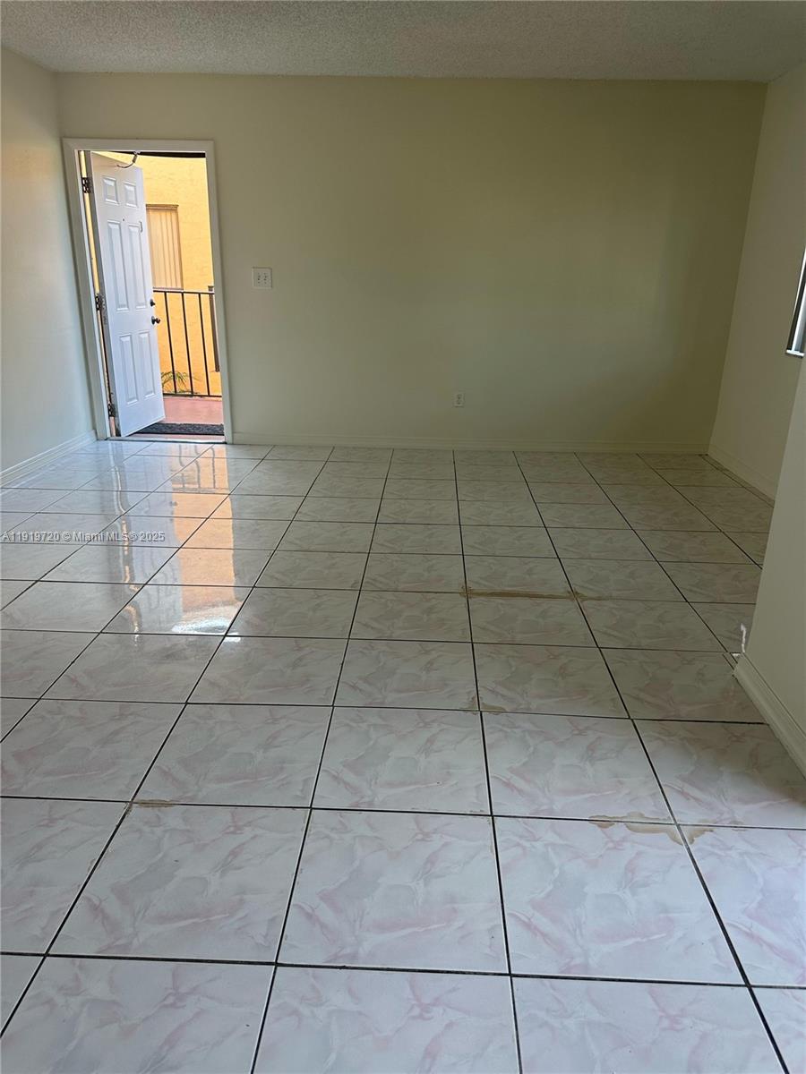 6031 10th Avenue North, Unit 218 Greenacres, FL 33463 - Photo 7 of 9 a view of an empty room with a window