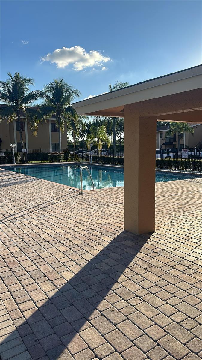 6031 10th Avenue North, Unit 218 Greenacres, FL 33463 - Photo 9 of 9 a view of swimming pool with lounge chair