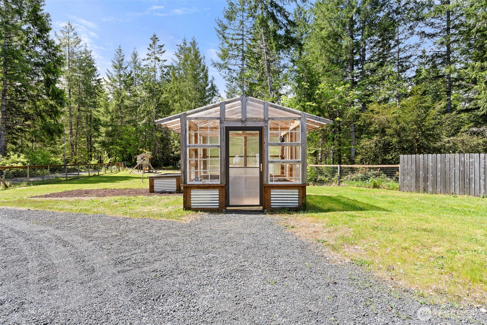 401 East Sunset Ridge Road Union, WA 98592 - Photo 23 of 37 a view of a house with backyard and trees
