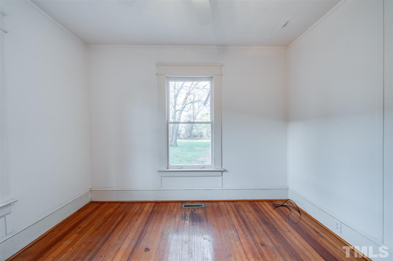 3133 Stanhope Avenue Raleigh, NC 27607 - Photo 14 of 21 a view of an empty room with wooden floor and a window