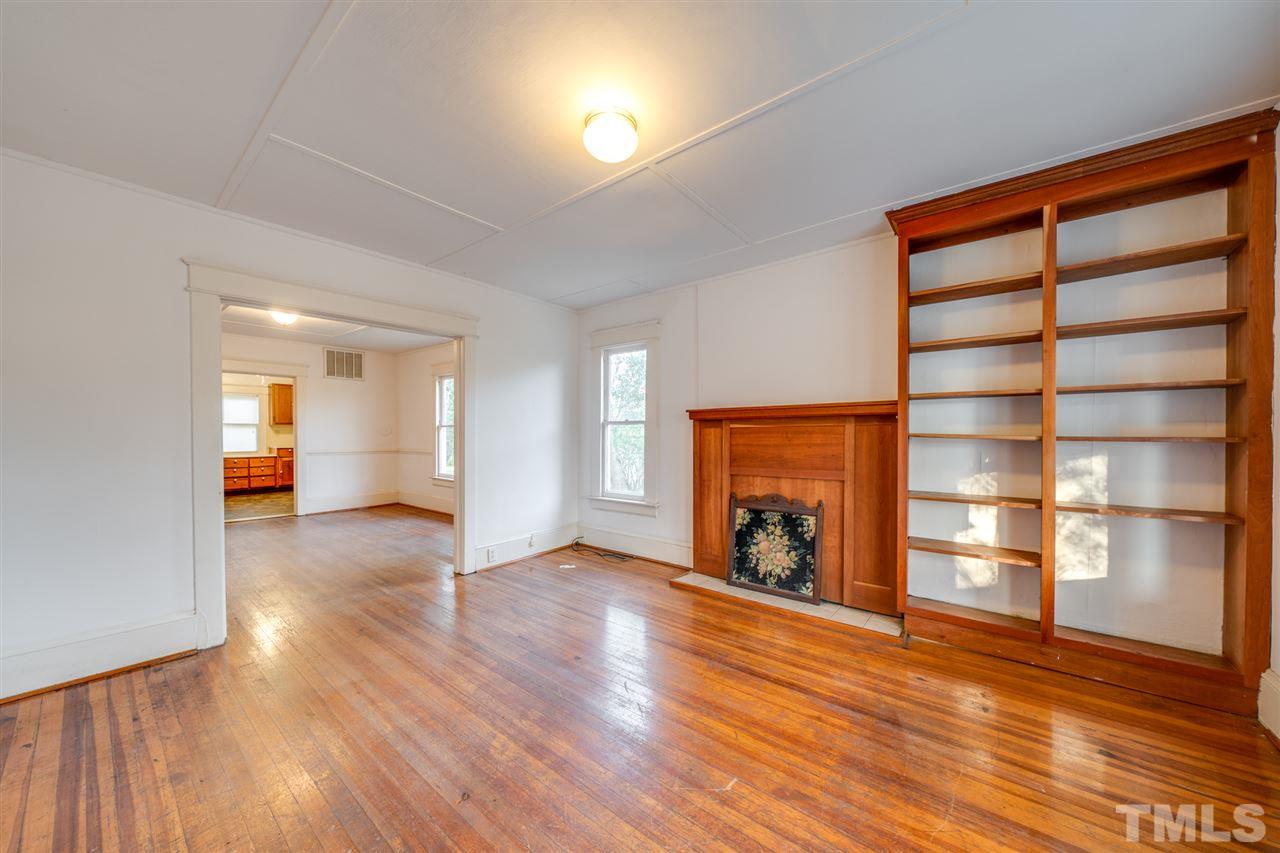 3133 Stanhope Avenue Raleigh, NC 27607 - Photo 3 of 21 a view of an empty room with a fireplace and a window