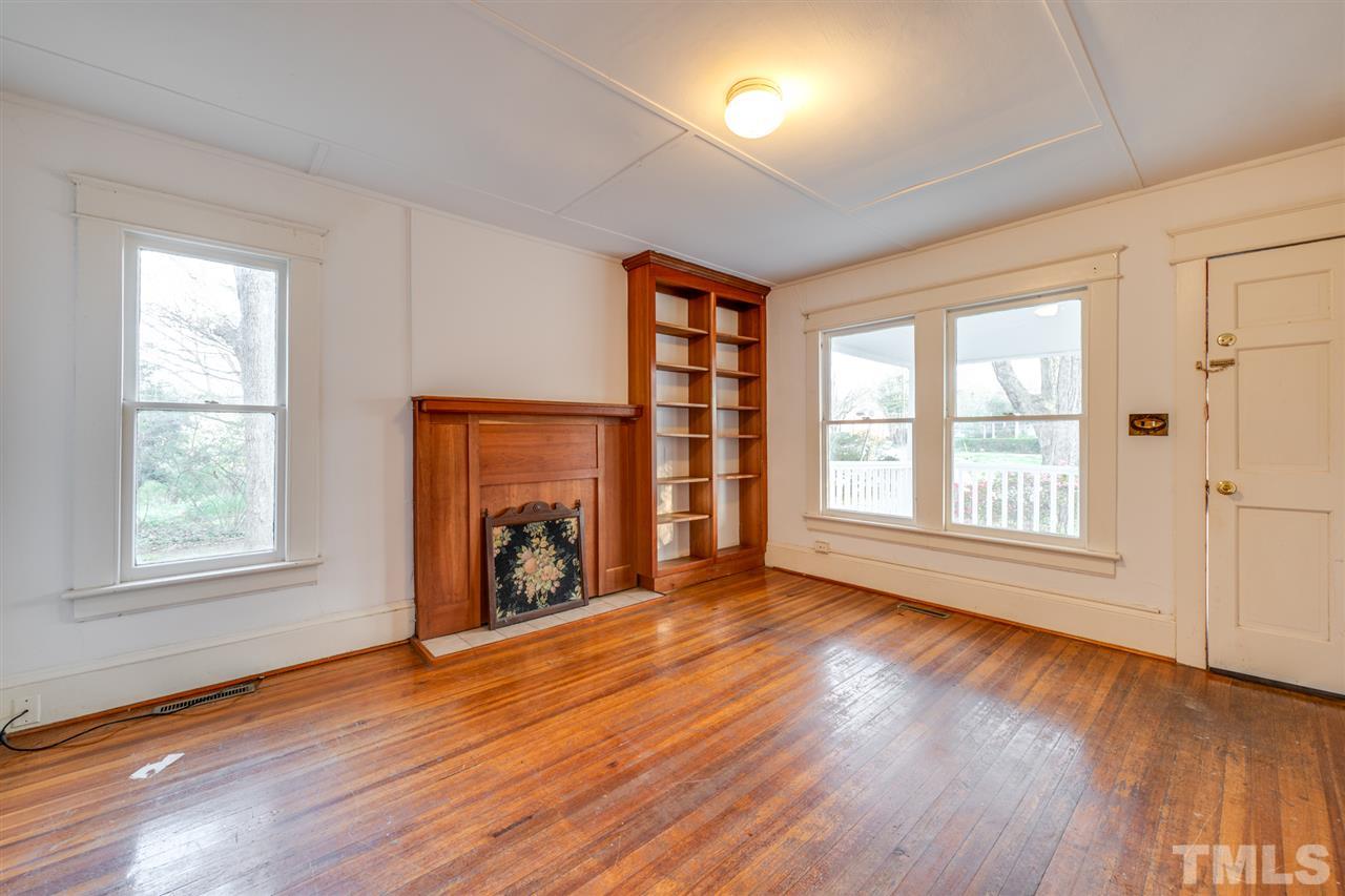 3133 Stanhope Avenue Raleigh, NC 27607 - Photo 5 of 21 a view of an empty room with wooden floor and a window