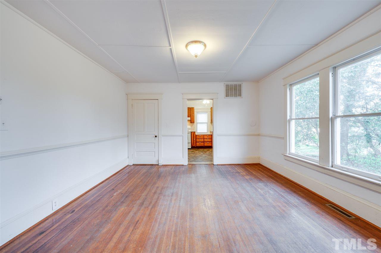 3133 Stanhope Avenue Raleigh, NC 27607 - Photo 6 of 21 an empty room with wooden floor and windows