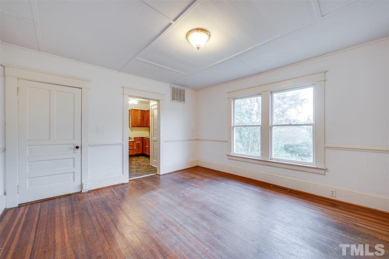 3133 Stanhope Avenue Raleigh, NC 27607 - Photo 7 of 21 an empty room with wooden floor and windows
