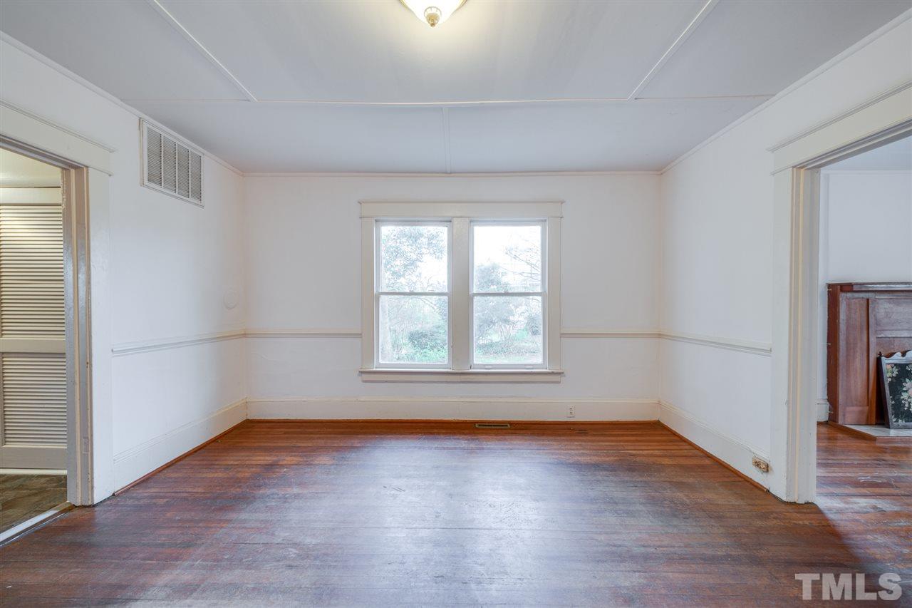 3133 Stanhope Avenue Raleigh, NC 27607 - Photo 8 of 21 an empty room with wooden floor and windows