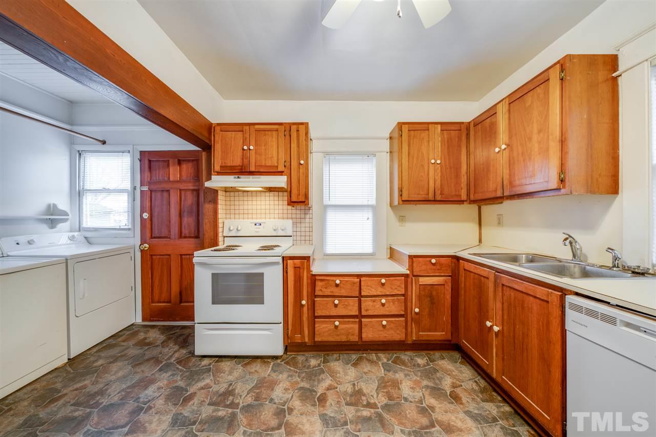 3133 Stanhope Avenue Raleigh, NC 27607 - Photo 9 of 21 a kitchen with stainless steel appliances a stove sink and cabinets