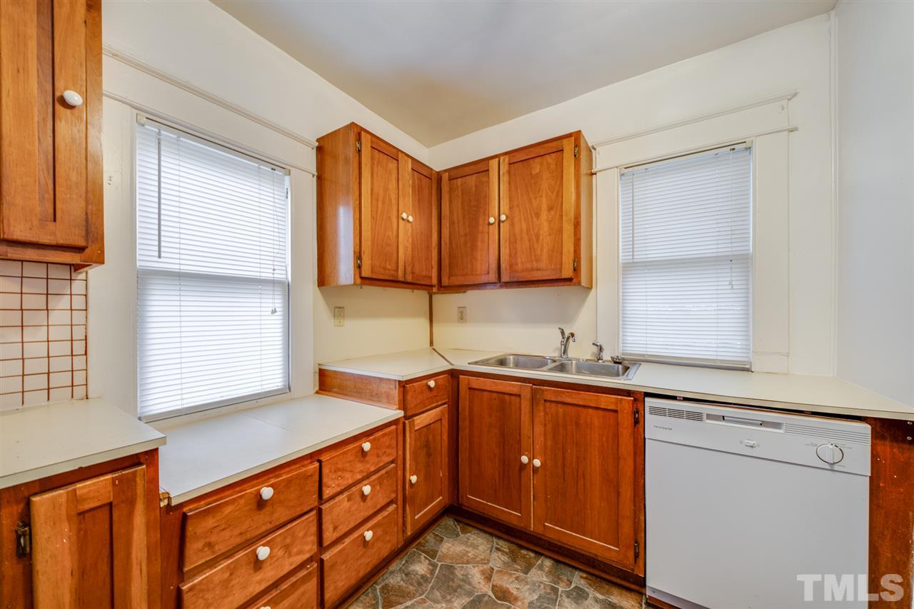 3133 Stanhope Avenue Raleigh, NC 27607 - Photo 10 of 21 a kitchen with stainless steel appliances granite countertop a sink stove and cabinets