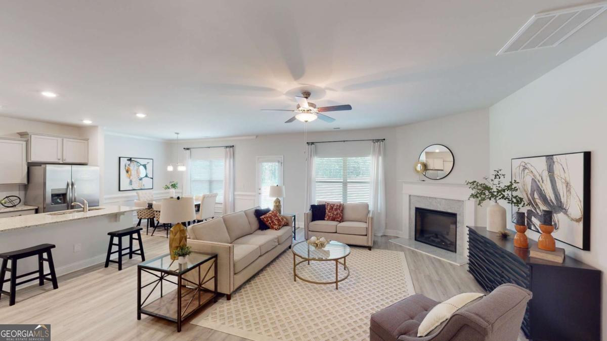 0 Maple Lane Williamson, GA 30292 - Photo 20 of 30 a living room with furniture a fireplace and a flat screen tv