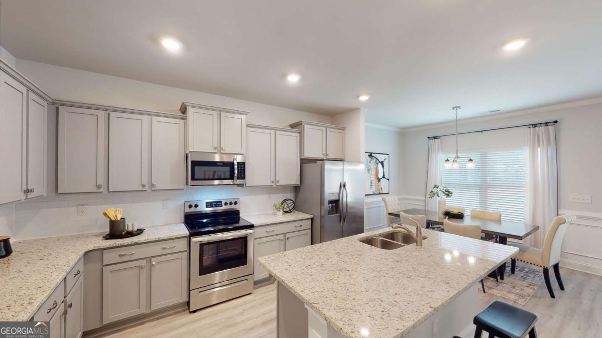 0 Maple Lane Williamson, GA 30292 - Photo 23 of 30 a kitchen with a refrigerator a stove a sink a dining table and chairs