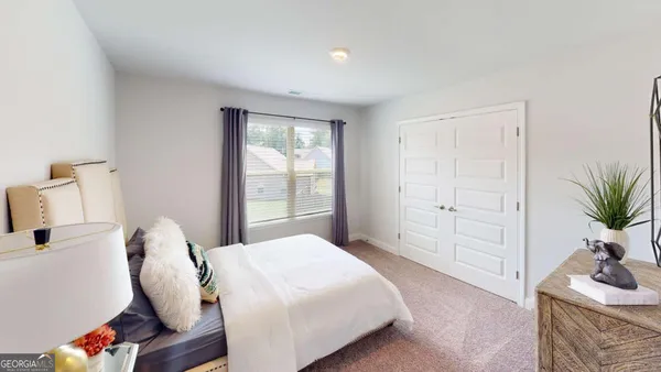 a bedroom with a bed and with furniture