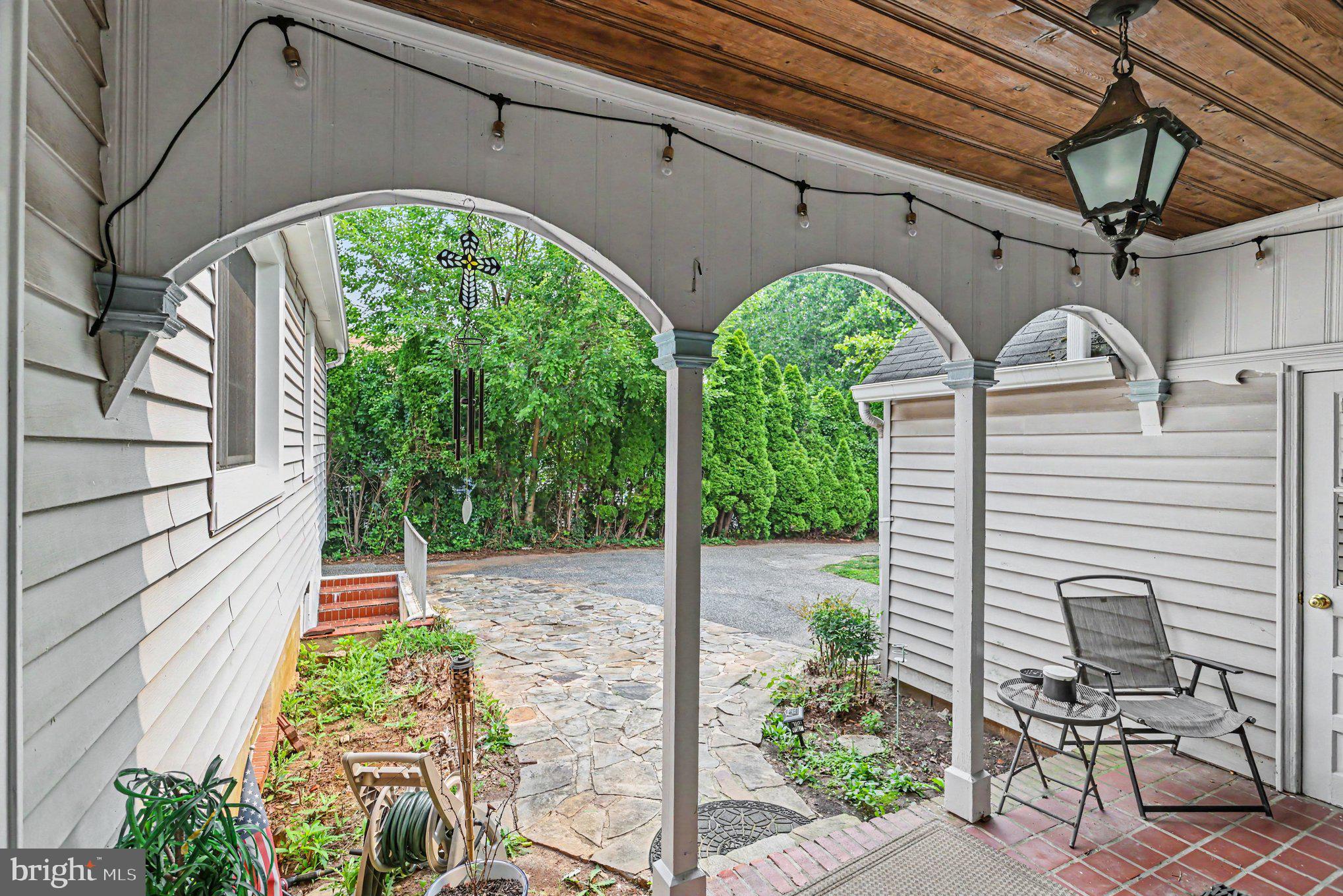 5912 Shady Spring Avenue Baltimore, MD 21237 - Photo 75 of 75 Charming entryway with lush greenery.