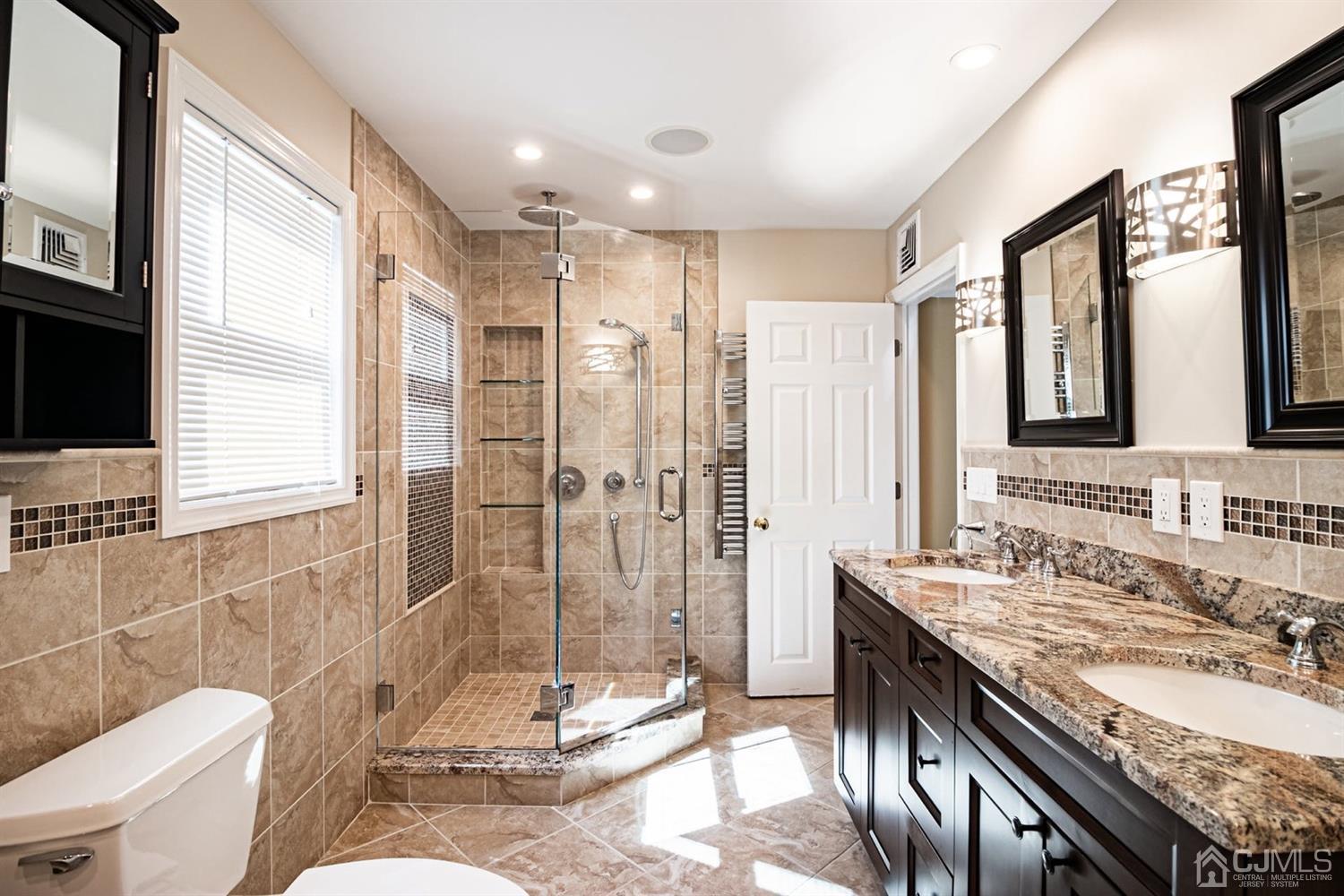 24 Kimberly Road Colonia, NJ 07067 - Photo 15 of 50 a bathroom with a granite countertop sink a toilet a mirror and shower