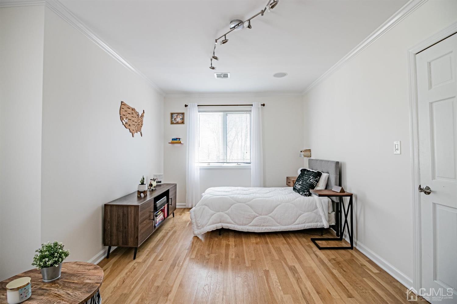 24 Kimberly Road Colonia, NJ 07067 - Photo 21 of 50 a bedroom with a bed and wooden floor