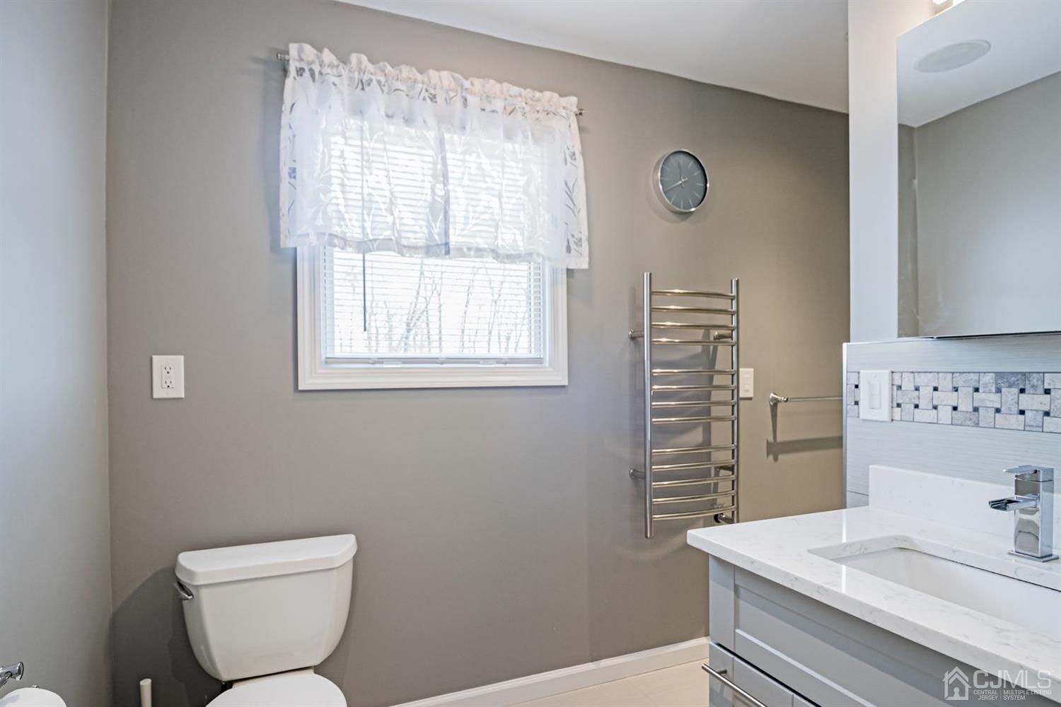 24 Kimberly Road Colonia, NJ 07067 - Photo 23 of 50 a bathroom with a toilet a sink and a window