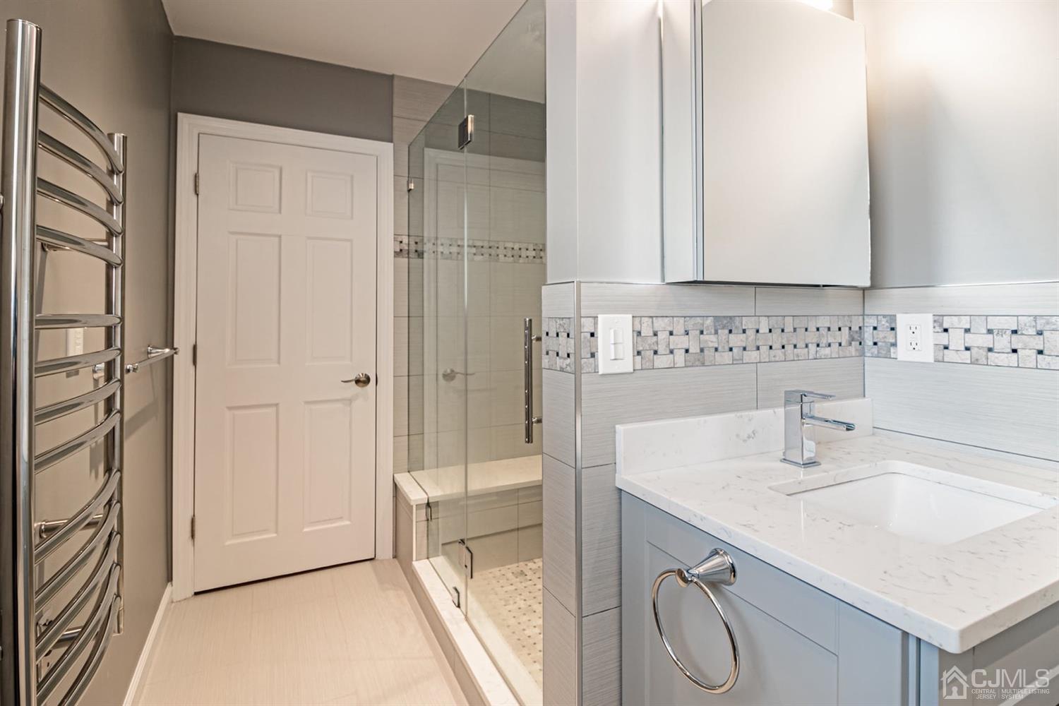24 Kimberly Road Colonia, NJ 07067 - Photo 24 of 50 a bathroom with a sink and a mirror