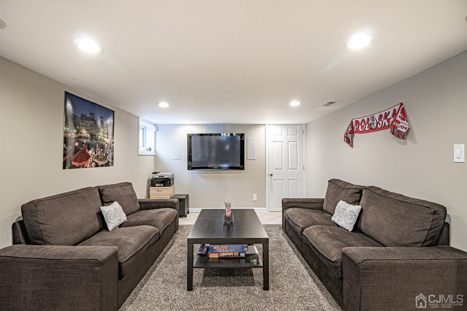 24 Kimberly Road Colonia, NJ 07067 - Photo 26 of 50 a living room with furniture and a flat screen tv
