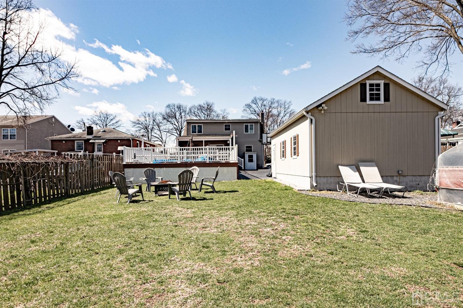 24 Kimberly Road Colonia, NJ 07067 - Photo 35 of 50 a backyard of a house with table and chairs