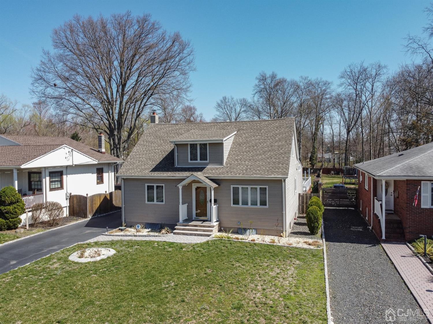 24 Kimberly Road Colonia, NJ 07067 - Photo 43 of 50 a view of a white house with a large pool lawn chairs and a fire pit