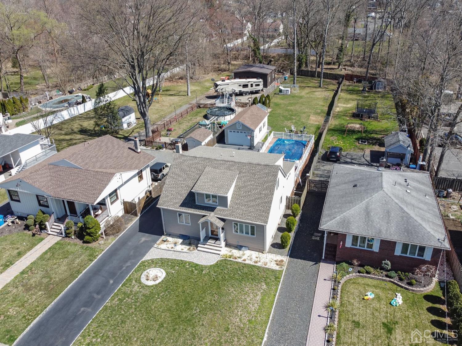 24 Kimberly Road Colonia, NJ 07067 - Photo 46 of 50 an aerial view of a house with swimming pool and large trees