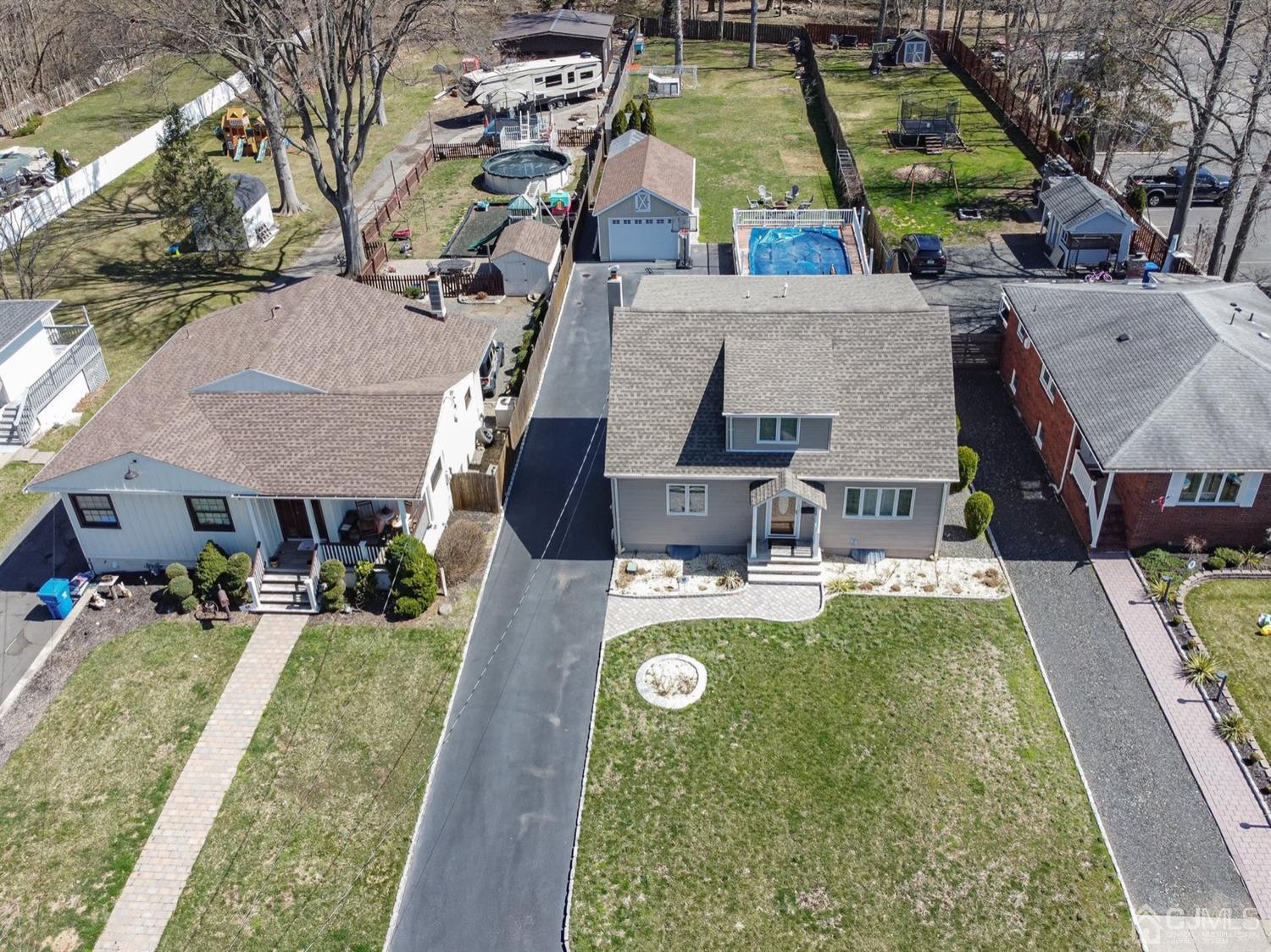 24 Kimberly Road Colonia, NJ 07067 - Photo 48 of 50 an aerial view of a house with swimming pool and large trees